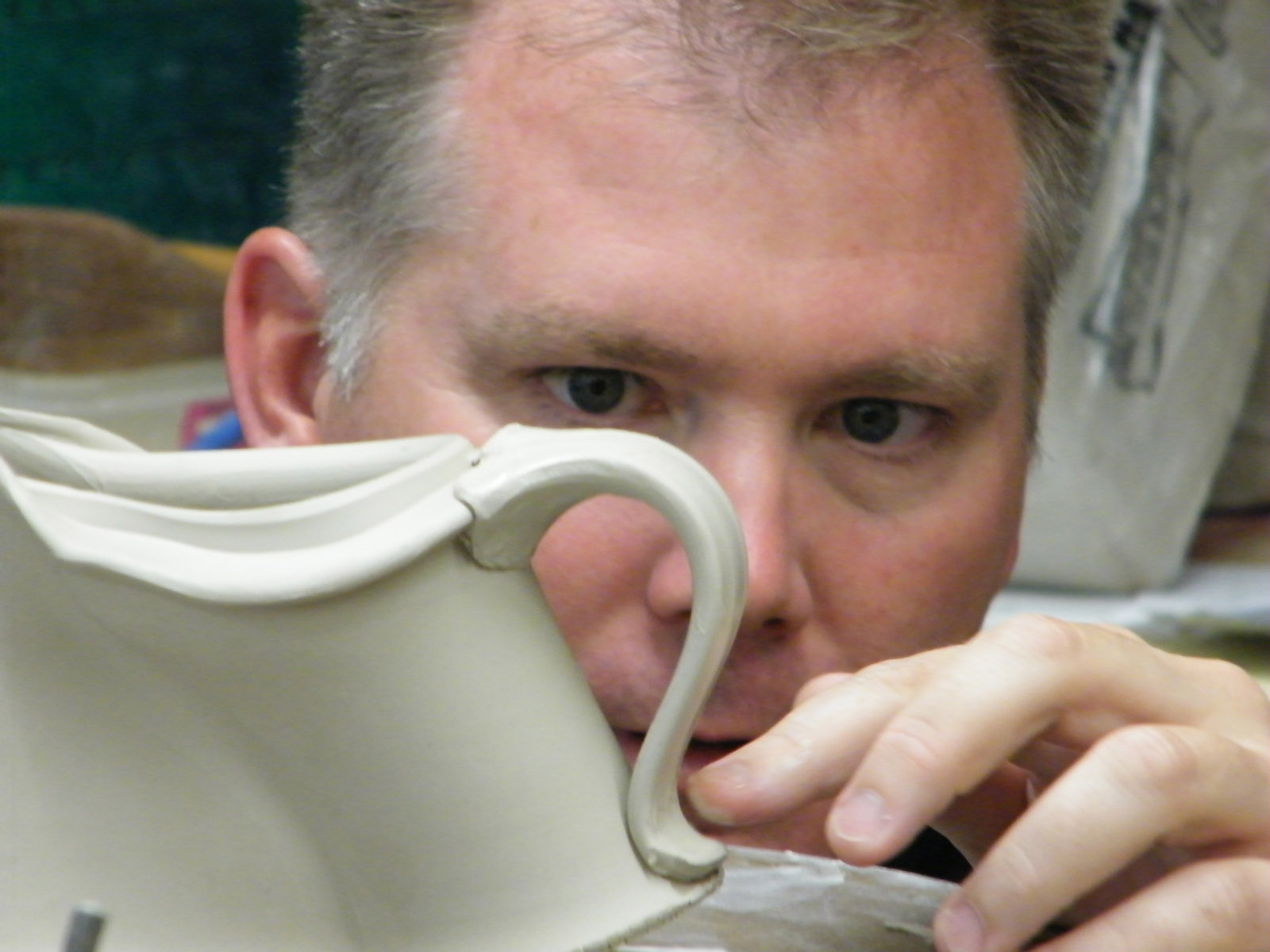 conner burns looking through a handle of a creamer while teaching a workshop at missa